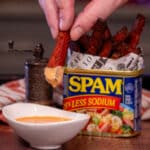dipping smoked spam fries in creamy sriracha sauce