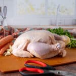 Raw whole chicken with brine ingredients and meat scissors