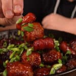 Smoked meatballs and sausages on a tooth pick with cranberry bourbon bbq sauce