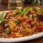 Italian fried rice with olives served on a white plater