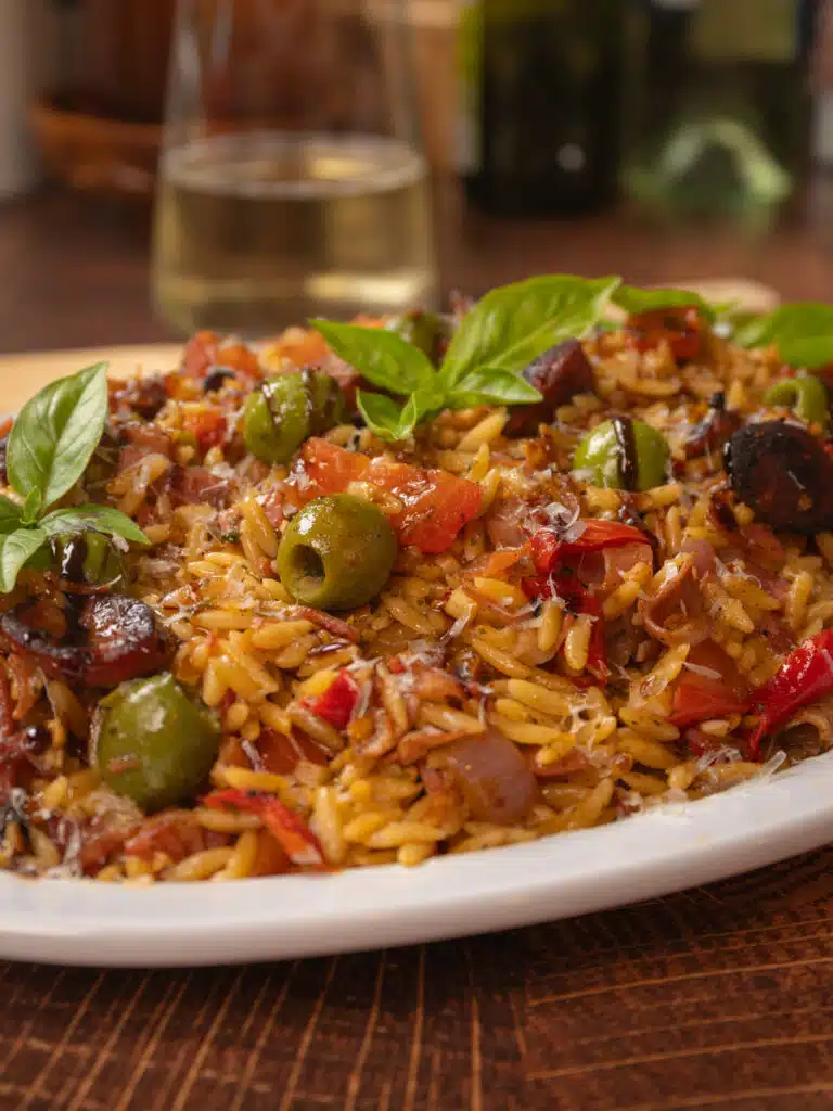 Italian fried rice with olives served on a white plater