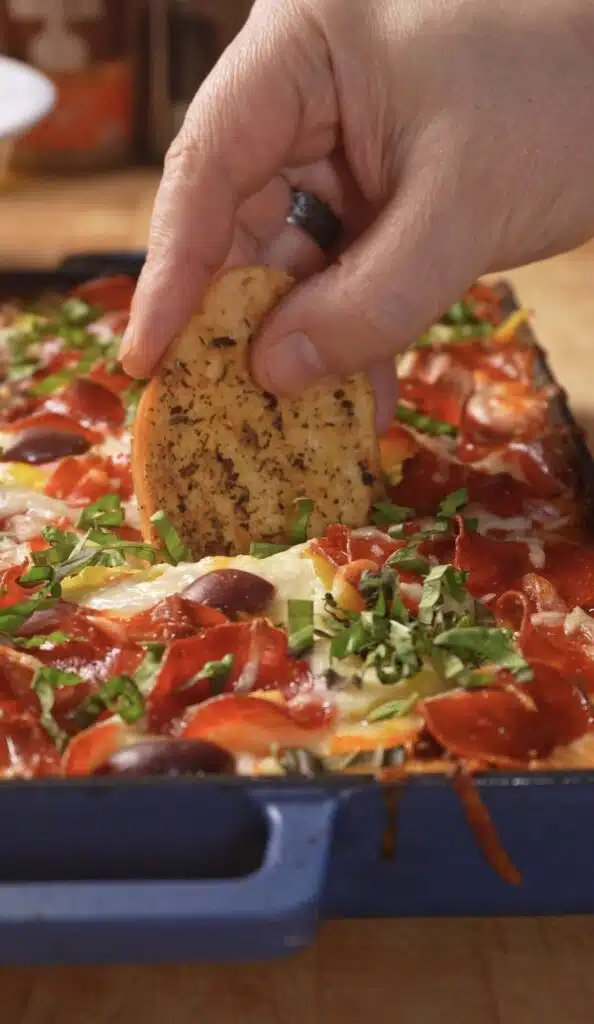 dipping bread into the pizza beans