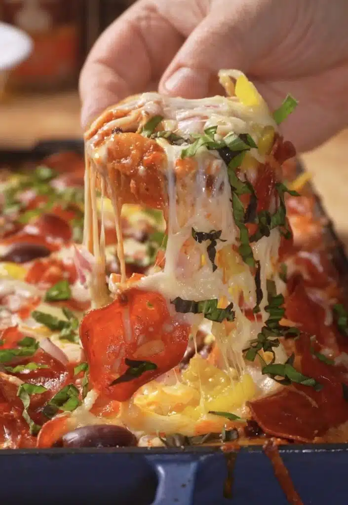 cheese pull scooping bread into the toppings