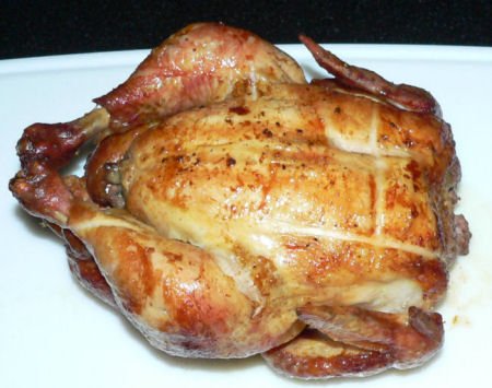 Rotisserie chicken on a charcoal grill