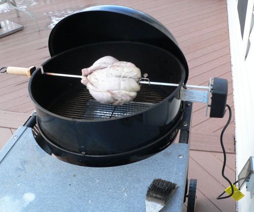 Rotisserie chicken on a charcoal grill