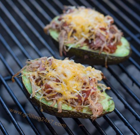 Grilled avocado with pulled pork, salsa, and cheese.